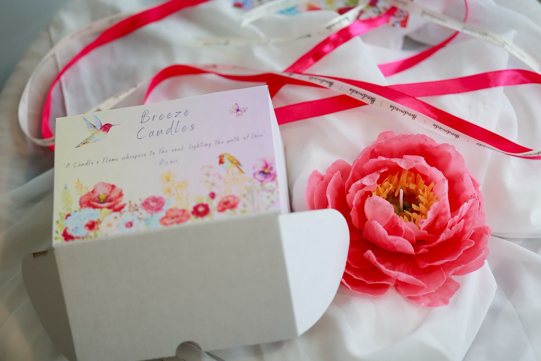 A coral peony floral candle.